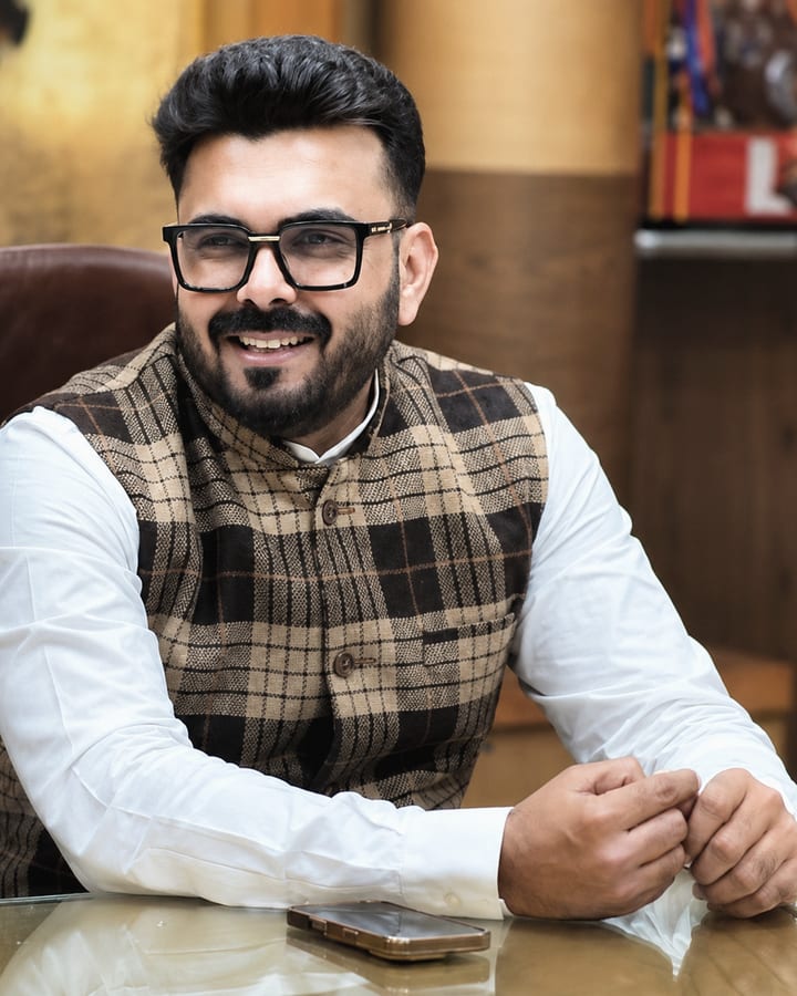 Abhishek Gopal Bhargava at his desk during a working conversation.
